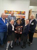 The winning team at Greta Bowden Academy receive their shield from Rotarians 